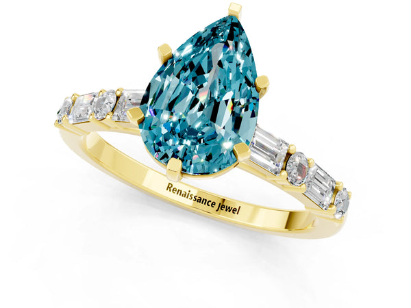 Yellow gold Pear Cut Blue Topaz Solitaire with Side Baguettes and Channel Set Band
