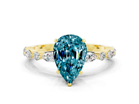 Yellow gold Pear Cut Blue Topaz Solitaire with Side Stones on a Pavé Band and Four-Prong Setting