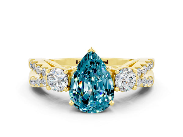 Yellow gold Pear Cut Blue Topaz Three-Stone Ring with Pavé Split Shank and Four-Prong Setting