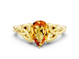 Yellow gold Pear Cut Citrine Solitaire Engagement Ring with Celtic Knot Band and Four-Prong Setting