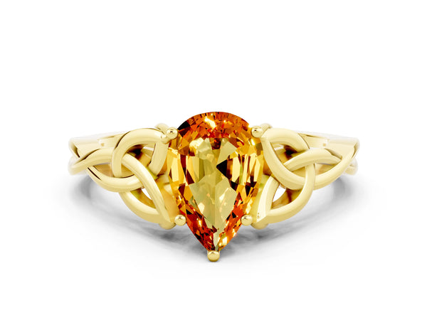Yellow gold Pear Cut Citrine Solitaire Engagement Ring with Celtic Knot Band and Four-Prong Setting