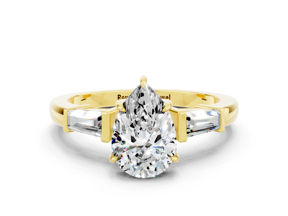 Yellow gold Pear Cut Cut Diamond Ring with Tapered Baguette Side Stones in Four-Prong Setting