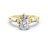 Yellow gold Pear Cut Cut Diamond Ring with Tapered Baguette Side Stones in Four-Prong Setting