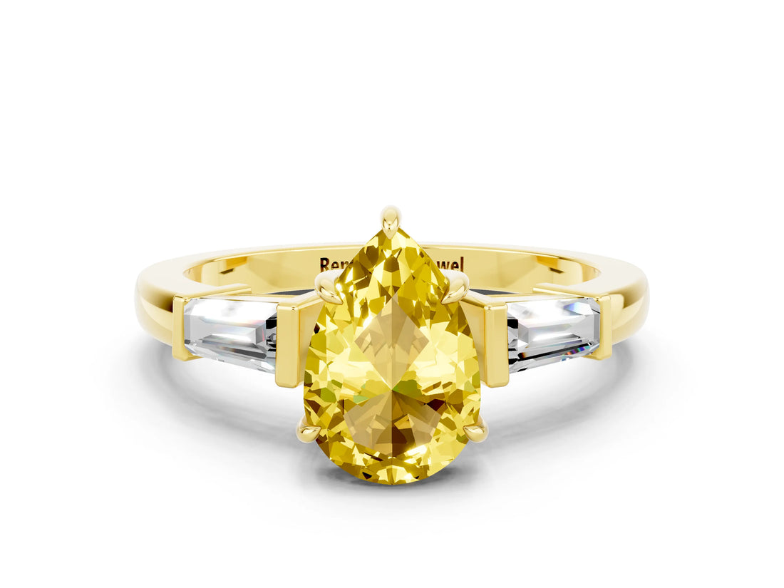 Yellow gold Pear Cut Cut Diamond Ring with Tapered Baguette Side Stones in Four-Prong Setting