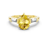 Yellow gold Pear Cut Cut Diamond Ring with Tapered Baguette Side Stones in Four-Prong Setting