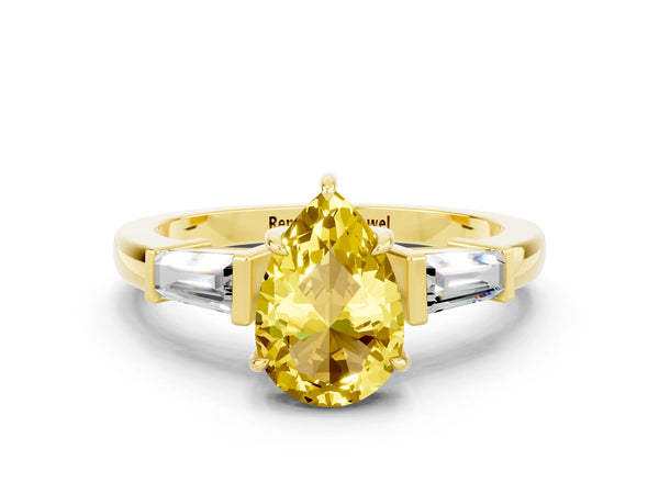Yellow gold Pear Cut Yellow Sapphire Three-Stone Ring with Tapered Baguette Side Stones and Prong Setting