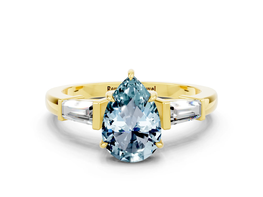 Yellow gold Pear Cut Cut Diamond Ring with Tapered Baguette Side Stones in Four-Prong Setting