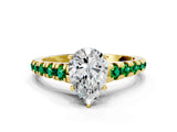 Yellow gold Pear Cut Diamond Cathedral Solitaire Ring with Round with Emerald side stone Pavé Band