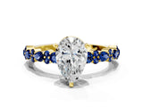 Yellow gold Pear Cut Diamond Side Stone Solitaire Ring with Round with Blue Sapphire side stone and Four-Prong Setting