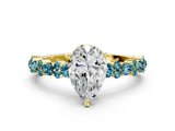 Yellow gold Pear Cut Diamond Side Stone Solitaire Ring with Round with Blue Topaz side stone and Four-Prong Setting