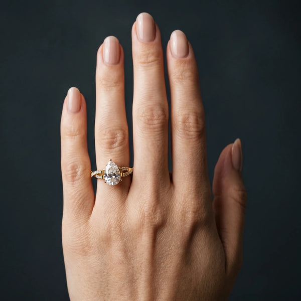 Yellow gold Pear Cut Diamond Solitaire Engagement Ring with Twisted Pavé Band and Four-Prong Setting