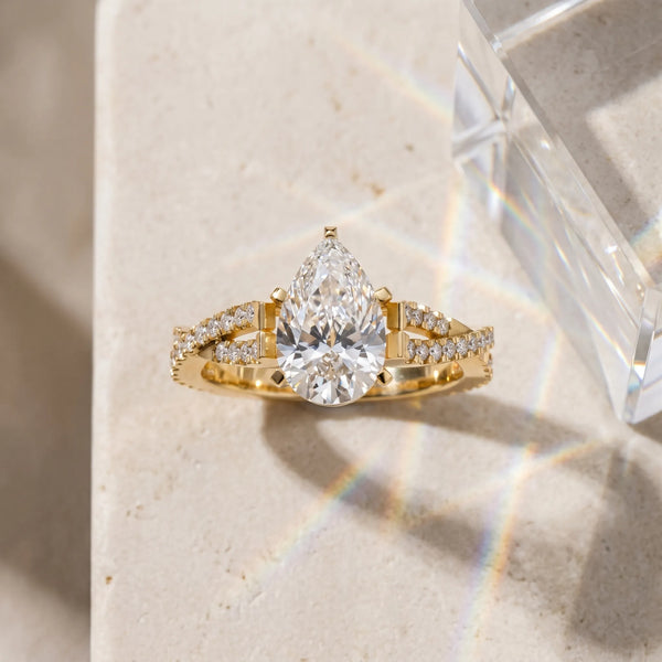 Yellow gold Pear Cut Diamond Solitaire Engagement Ring with Twisted Pavé Band and Four-Prong Setting