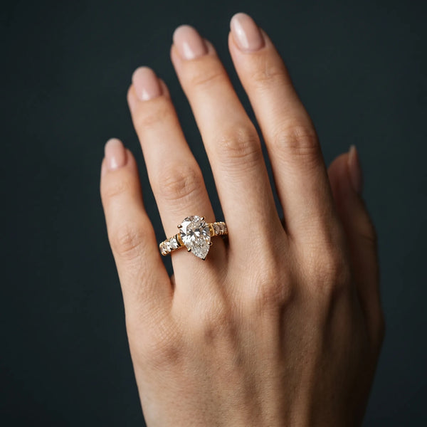 Yellow gold Pear Cut Diamond Solitaire Ring with Micro Pave Band and Prong Setting