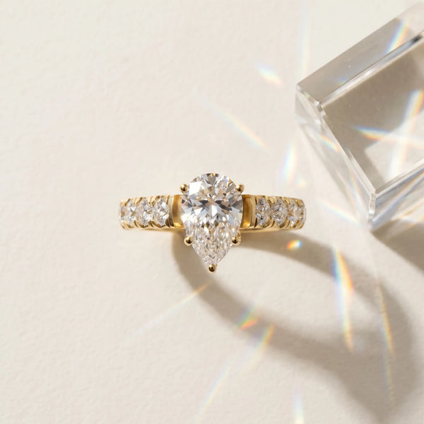 Yellow gold Pear Cut Diamond Solitaire Ring with Micro Pave Band and Prong Setting
