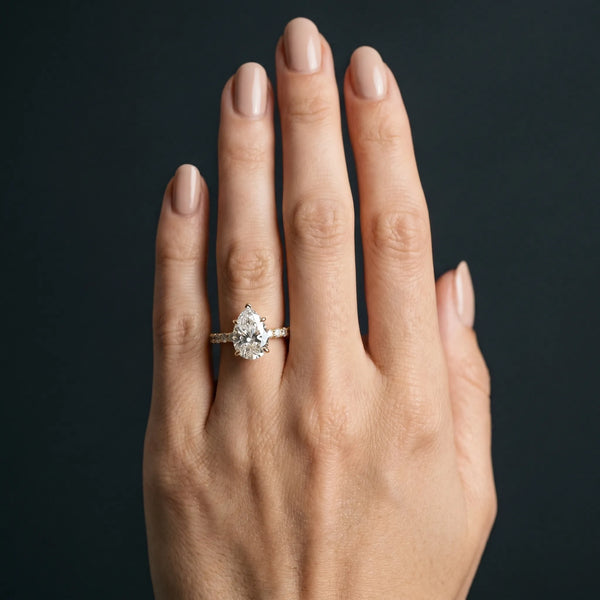 Yellow gold Pear Cut Diamond Solitaire Ring with U-Prong Diamond Band and Four Prong Setting