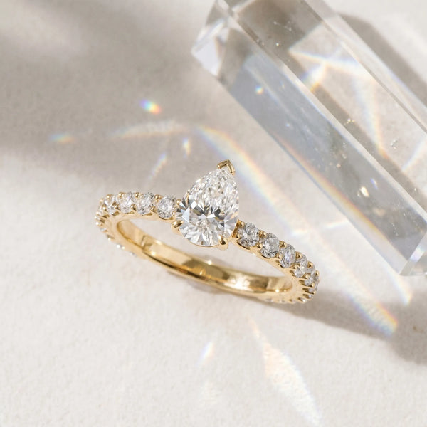 Yellow gold Pear Cut Diamond Solitaire Ring with U-Prong Diamond Band and Four Prong Setting