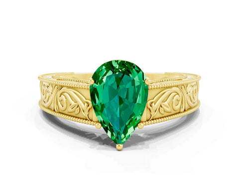 Yellow gold Pear Cut Emerald Solitaire Ring with Engraved Band and Four-Prong Setting