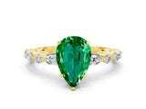 Yellow gold Pear Cut Emerald Solitaire with Side Stones on a Pavé Band and Four-Prong Setting