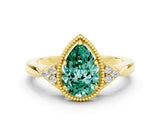 Yellow gold Pear Cut Green Sapphire Halo Ring with Tapered Band and Four-Prong Setting