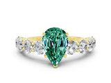 Yellow gold Pear Cut Green Sapphire Prong Setting with Side Stones on a Pave Band