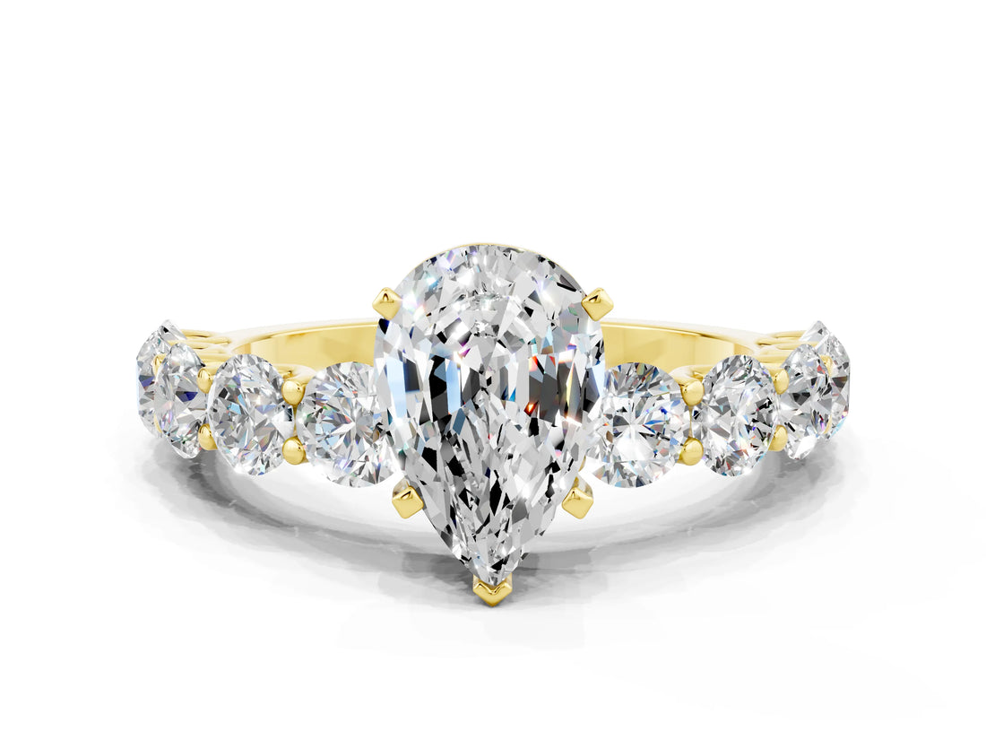 Yellow gold Pear Cut Moissanite Prong Setting with Side Stones on a Pave Band