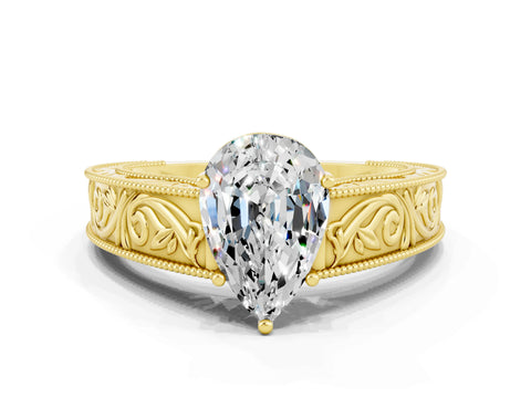 Yellow gold Pear Cut Moissanite Solitaire Ring with Engraved Band and Four-Prong Setting