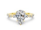 Yellow gold Pear Cut Moissanite Solitaire with Side Stones on a Pavé Band and Four-Prong Setting