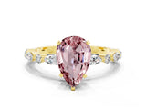 Yellow gold Pear Cut Morganite Solitaire with Side Stones on a Pavé Band and Four-Prong Setting