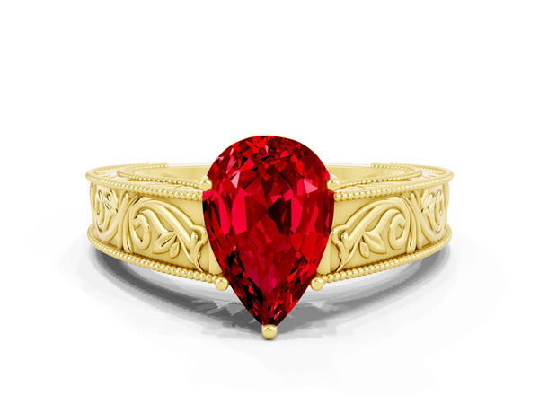 Yellow gold Pear Cut Ruby Solitaire Ring with Engraved Band and Four-Prong Setting
