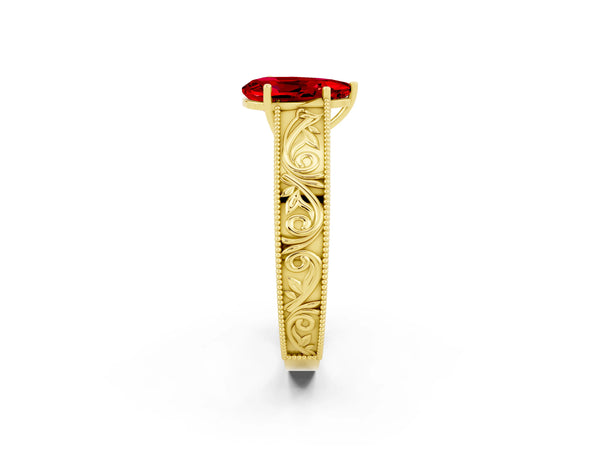 Yellow gold Pear Cut Ruby Solitaire Ring with Engraved Band and Four-Prong Setting