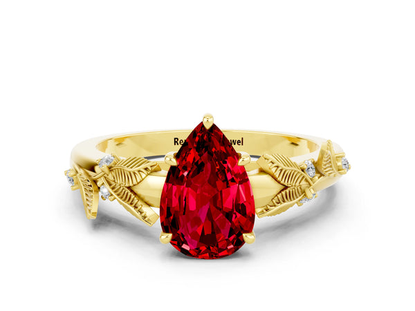 Yellow gold Pear Cut Ruby Solitaire Ring with Leaf Motif Band and Four-Prong Setting