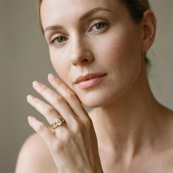 Yellow gold Pear Cut Solitaire Diamond with Side Stones on Criss-Cross Band and Four-Prong Setting