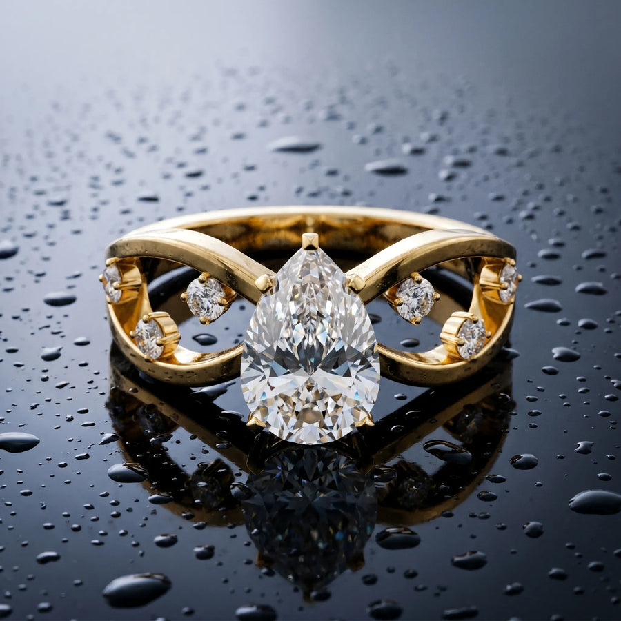 Yellow gold Pear Cut Solitaire Diamond with Side Stones on Criss-Cross Band and Four-Prong Setting