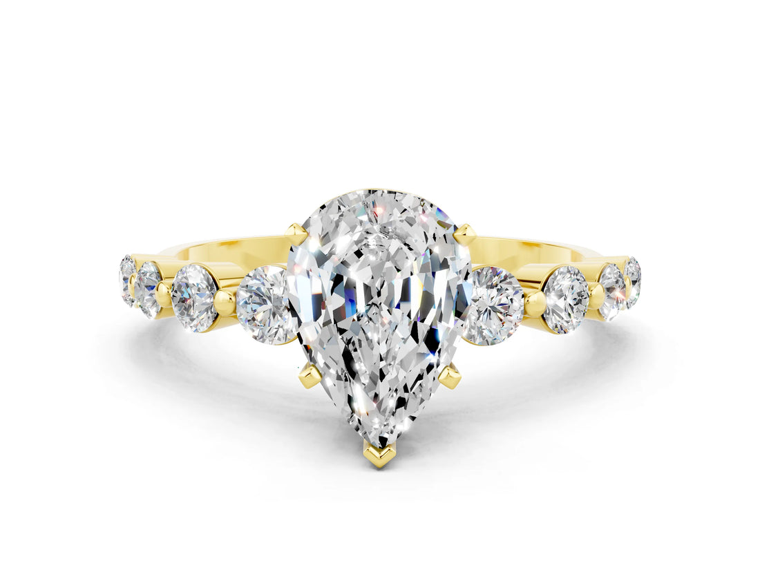 Yellow gold Pear Cut Solitaire Moissanite Ring with Pave Band and Four-Prong Setting