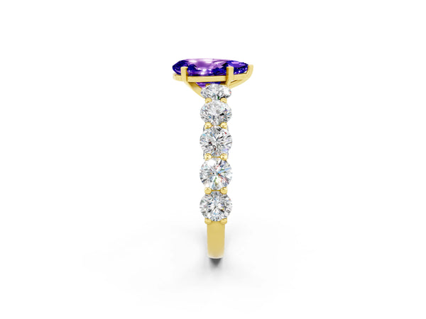 Yellow gold Pear Cut Tanzanite Prong Setting with Side Stones on a Pave Band