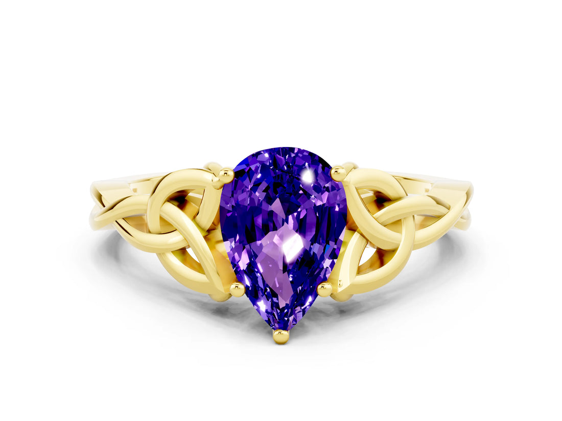 Yellow gold Pear Cut Tanzanite Solitaire Engagement Ring with Celtic Knot Band and Four-Prong Setting