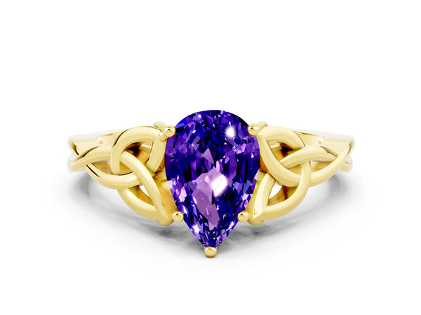 Yellow gold Pear Cut Tanzanite Solitaire Engagement Ring with Celtic Knot Band and Four-Prong Setting