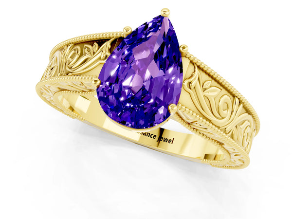 Yellow gold Pear Cut Tanzanite Solitaire Ring with Engraved Band and Four-Prong Setting