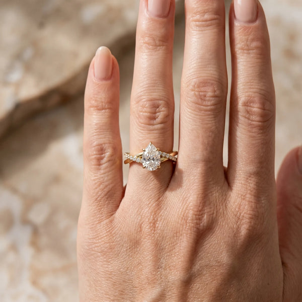 Yellow gold Pear Cut Twist Band Solitaire Diamond Ring with Pavé Setting