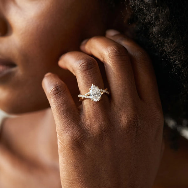 Yellow gold Pear Cut Twist Band Solitaire Diamond Ring with Pavé Setting