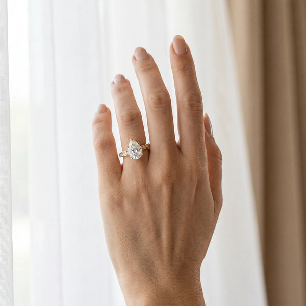 Yellow gold Pear Diamond Solitaire with Pave Band and Six-Prong Setting