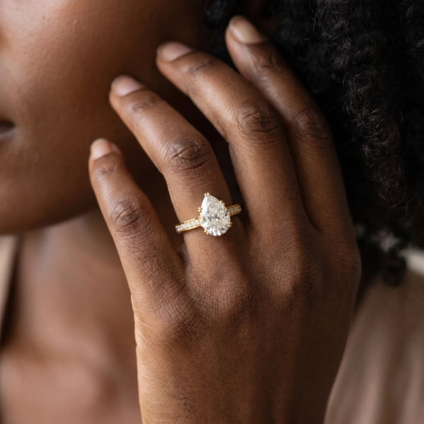 Yellow gold Pear Diamond Solitaire with Pave Band and Six-Prong Setting