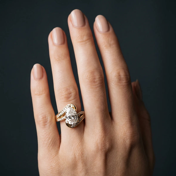 Yellow gold Pear Solitaire Bypass Diamond Engagement Ring with Channel-Set Band and Four-Prong Setting