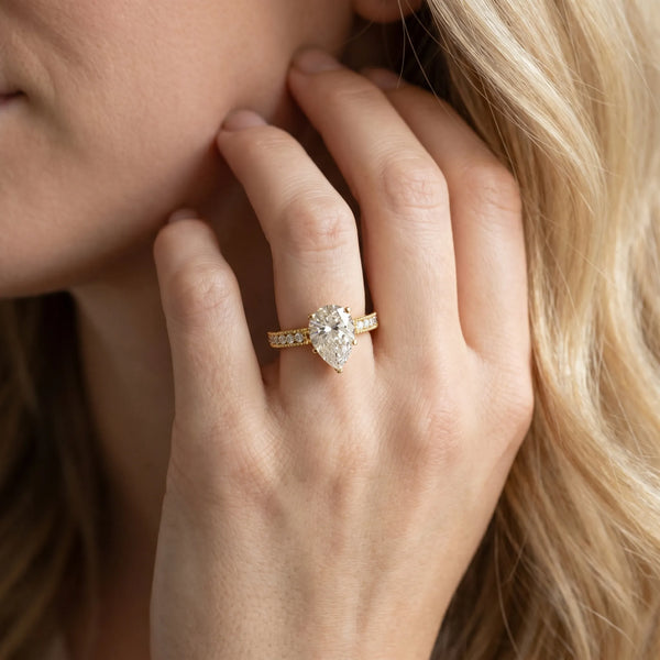 Yellow gold Pear Solitaire with Pavé Band and Four-Prong Setting