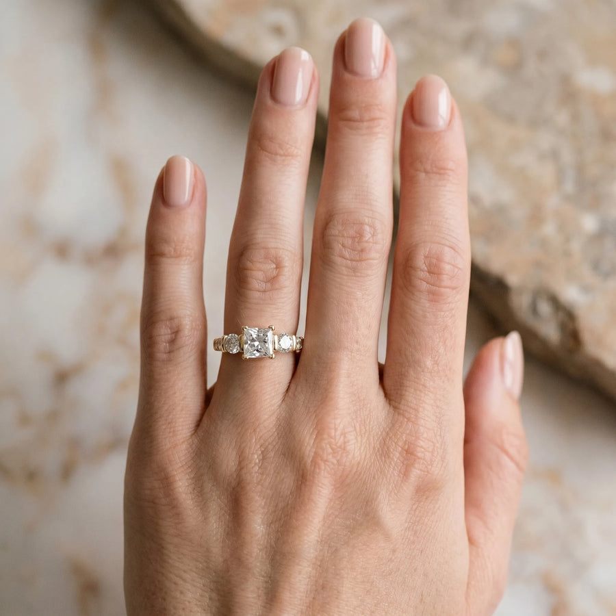 Yellow gold Princess Brilliant Trilogy Channel Set Diamond Ring with Bar Prongs