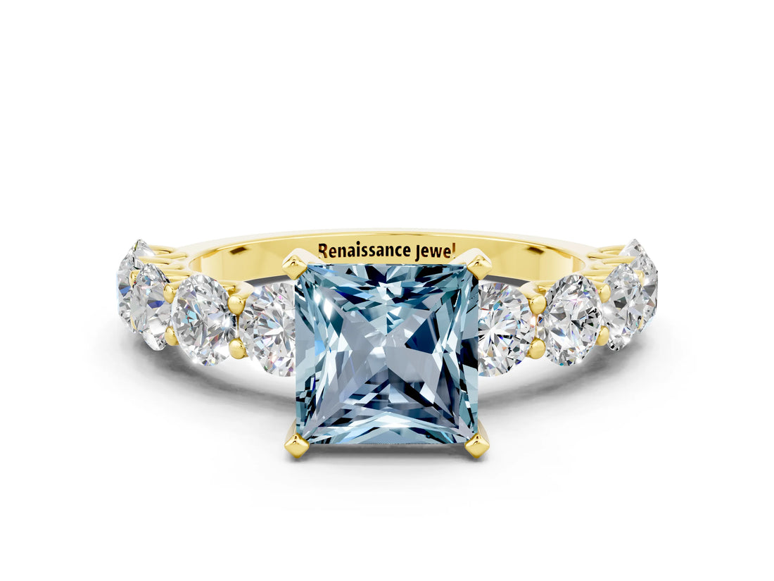Yellow gold Princess Cut Aquamarine Prong Setting with Side Stones on a Pave Band
