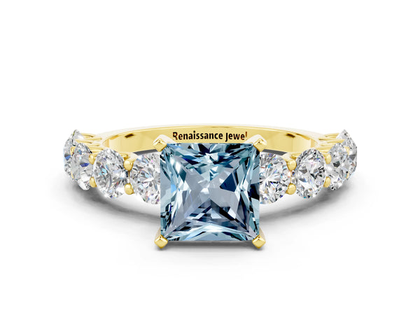 Yellow gold Princess Cut Aquamarine Prong Setting with Side Stones on a Pave Band