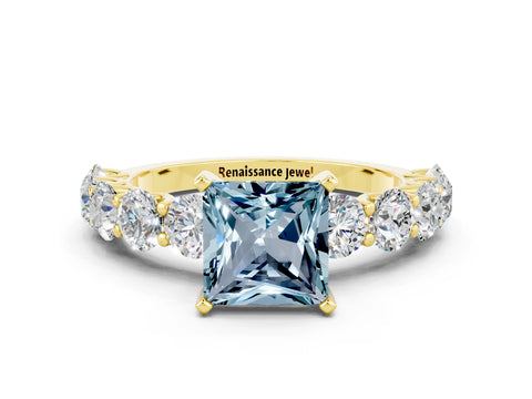 Yellow gold Princess Cut Aquamarine Prong Setting with Side Stones on a Pave Band