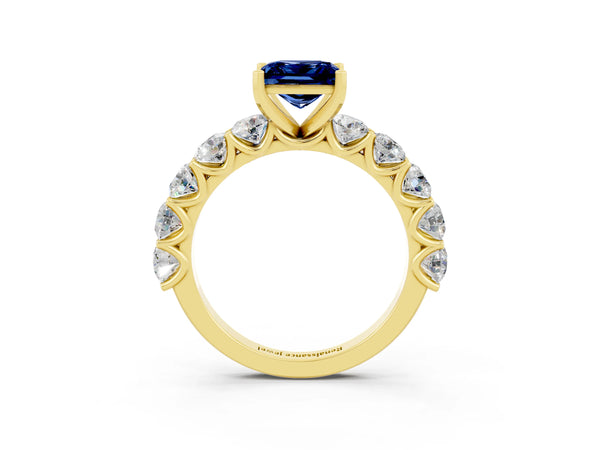 Yellow gold Princess Cut Blue Sapphire Prong Setting with Side Stones on a Pave Band