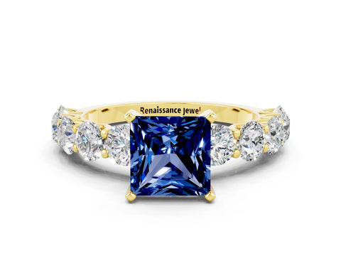 Yellow gold Princess Cut Blue Sapphire Prong Setting with Side Stones on a Pave Band